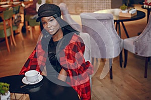 Elegant black girl in a cafe
