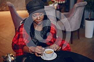 Elegant black girl in a cafe