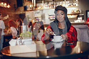 Elegant black girl in a cafe