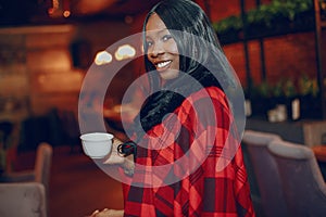 Elegant black girl in a cafe