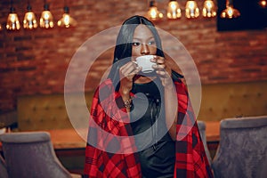 Elegant black girl in a cafe