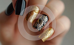 Elegant black and gold nail art design showcasing intricate details and creativity photo