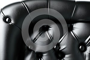 Close-up of isolated black leather sofa