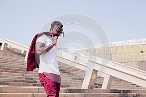 Elegant black man walking down a city staircase