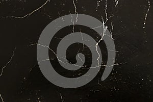 Elegant black marble texture with subtle white veins, perfect for backgrounds or interior design projects.