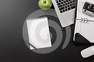 Elegant black office desktop with laptop and cup of coffee. Top view