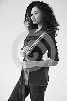 Elegant black woman with curly hair in fashionable green suit