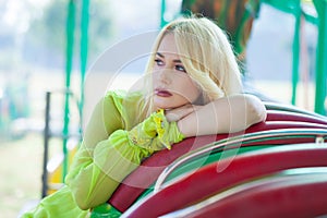 Elegant blonde fashion woman portrait in amusement park summe