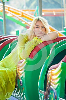Elegant blonde fashion woman portrait in amusement park summer