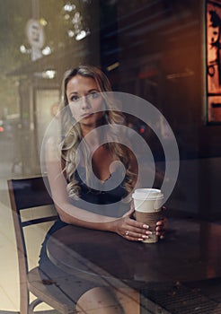 Elegant blonde woman drinking coffee