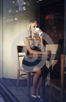 Elegant blonde woman drinking coffee