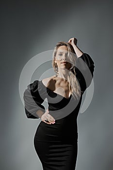 Elegant Blonde Woman in Little Black Fashion Dress