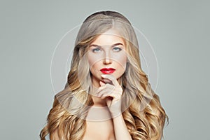 Elegant blonde woman with long wavy hair. Thinking fashion model portrait