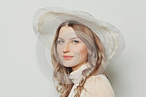 Elegant blonde woman in summer hat, close up portrait