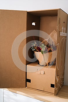 Elegant bouquet flower arrangement by florist in a box prepared for transport on a wooden table