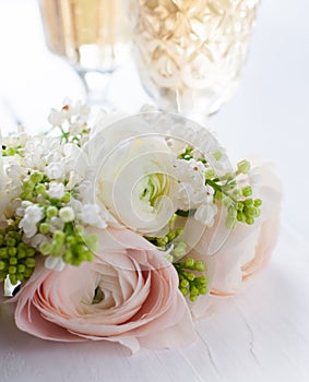 Elegant bouquet of flowers and two glasses of wine