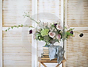 Elegant bouquet of pink flowers and ancient books