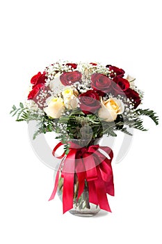 Elegant bouquet of red, white roses, decorated with fern leaves, ribbons, flowers clear vase white