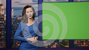 Elegant breaking news reporter showing information green screen studio close up.