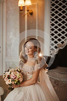Elegant bride with closed eyes. Stylish young woman in a wedding dress. Beautiful female model with bridal make-up and