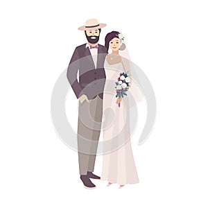 Elegant bride dressed in fancy vintage gown and groom wearing stylish suit and hat. Loving man and woman at wedding