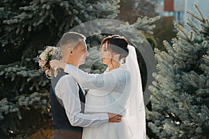 Elegant bride and groom posing together outdoors on a wedding day. Groom and Bride in a park. wedding dress. Bridal