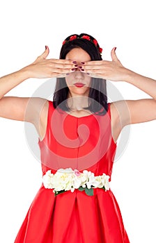 Elegant brunette girl with a red flower crown covering her eyes