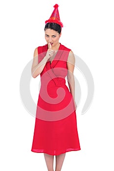 Elegant brunette in red dress preparing a secret party