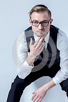 Elegant business man with glasses reflects concentrated