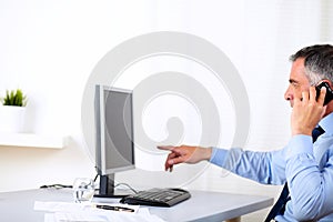 Elegant business man pointing the computer