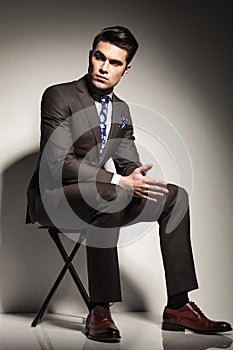 Elegant business man sitting and looking to his side