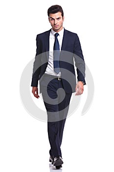 Elegant business man walking on white background