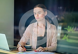 Elegant business woman looking through the window in a cafe shop. Thoughtful Look. Selective focus and reflexion on window