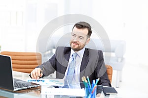 Elegant businessman analyzing data in office