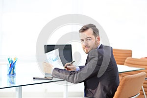 Elegant businessman analyzing data in office