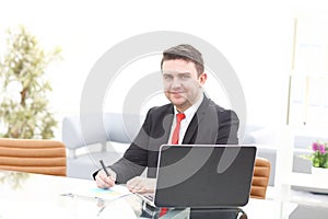 Elegant businessman analyzing data in office