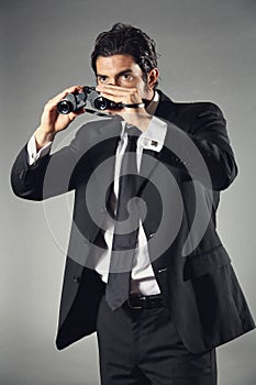 Elegant businessman with binocular