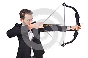 Elegant businessman shooting bow and arrow