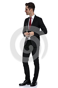 Elegant businessman and unbuttoning his jacket