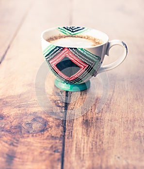 Elegant cappuccino mug with skimmed milk isolated on wooden table