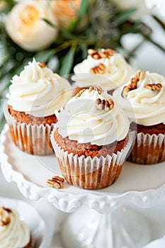 Elegant Carrot Cupcakes Topped With Cream Cheese Frosting on a Ceramic Stand