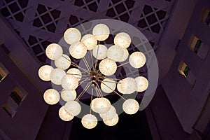 Elegant chandelier on the ceiling of big hall