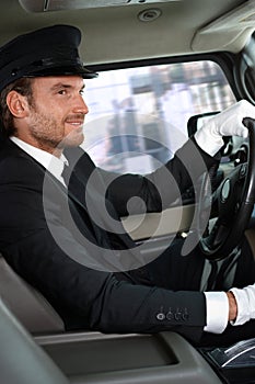 Elegant chauffeur driving luxurious car