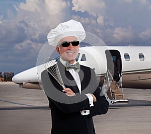 Elegant chef posing in front of a private jet