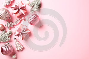 Elegant Christmas background with balls, gift boxes, fir branches, ornaments on pink. Flat lay, top view, copy space