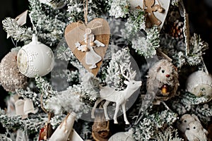Elegant Christmas tree decorated with a lot of toys: deer, balls, angels and different animals