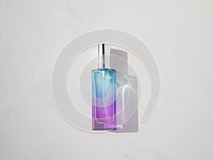 Elegant colored purple with blue rectangular perfume bottle. Cosmetic container with color gradient. Pink perfume botlle