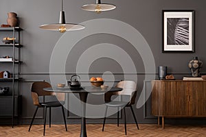 Elegant composition of living room interior with mock up posters frames, round table, lamp, wooden sideboard, rack, dark wall with