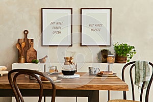 Elegant composition of stylish dining room interior with mock up poster frames, beige sideboard, family dining table, plants.