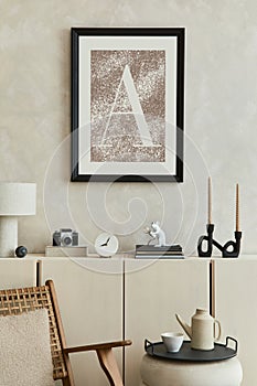 Elegant composition of stylish living room interior with mock up poster frame, beige sideboard and minimalistic personal.